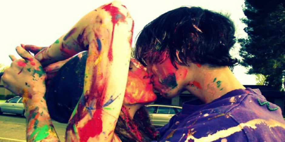 couple kissing covered in paint