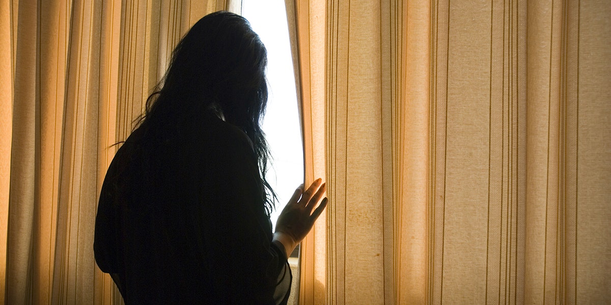 woman in shadow on phone