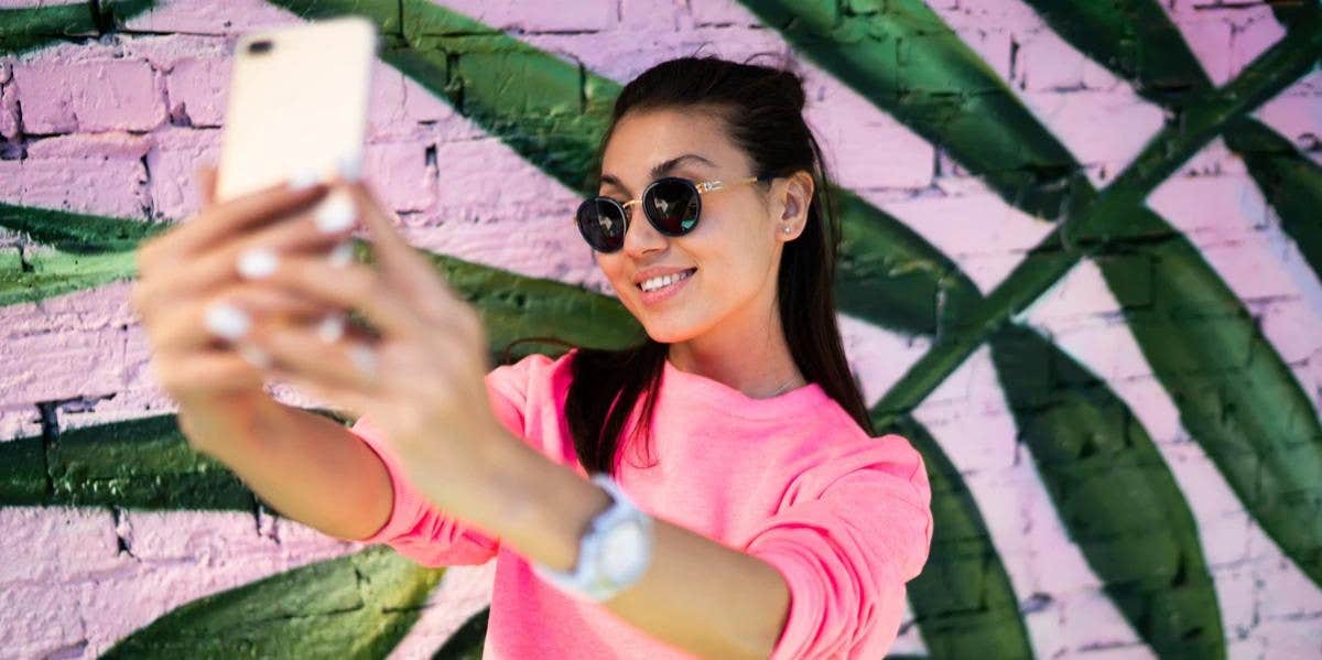 What Are Parasocial Relationships And Are They Healthy? woman taking selfie