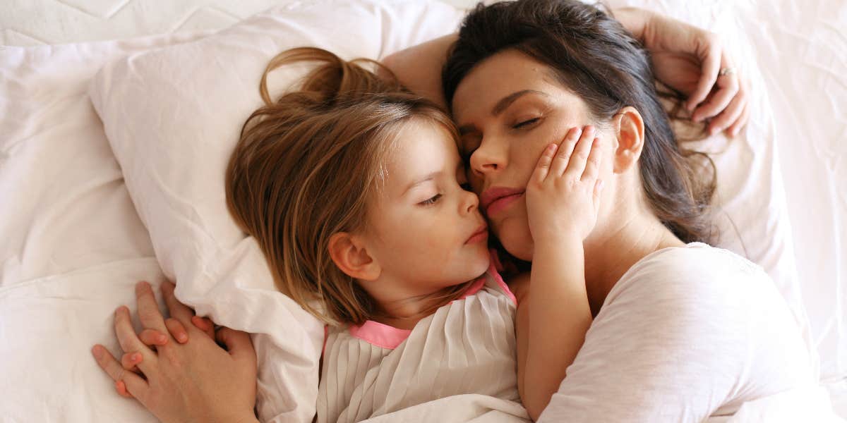 Parent Sparks Debate After Saying They Lock Their Bedroom Door To Stop Their Child From Coming In Mom and child in bed