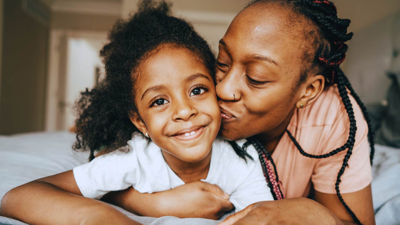 parent kissing their child