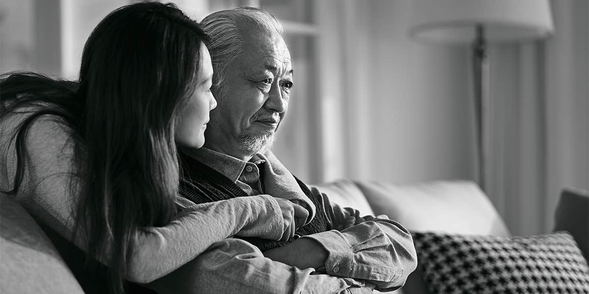 daughter hugging elderly father