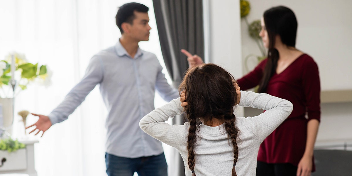 girl listening to parents arguing