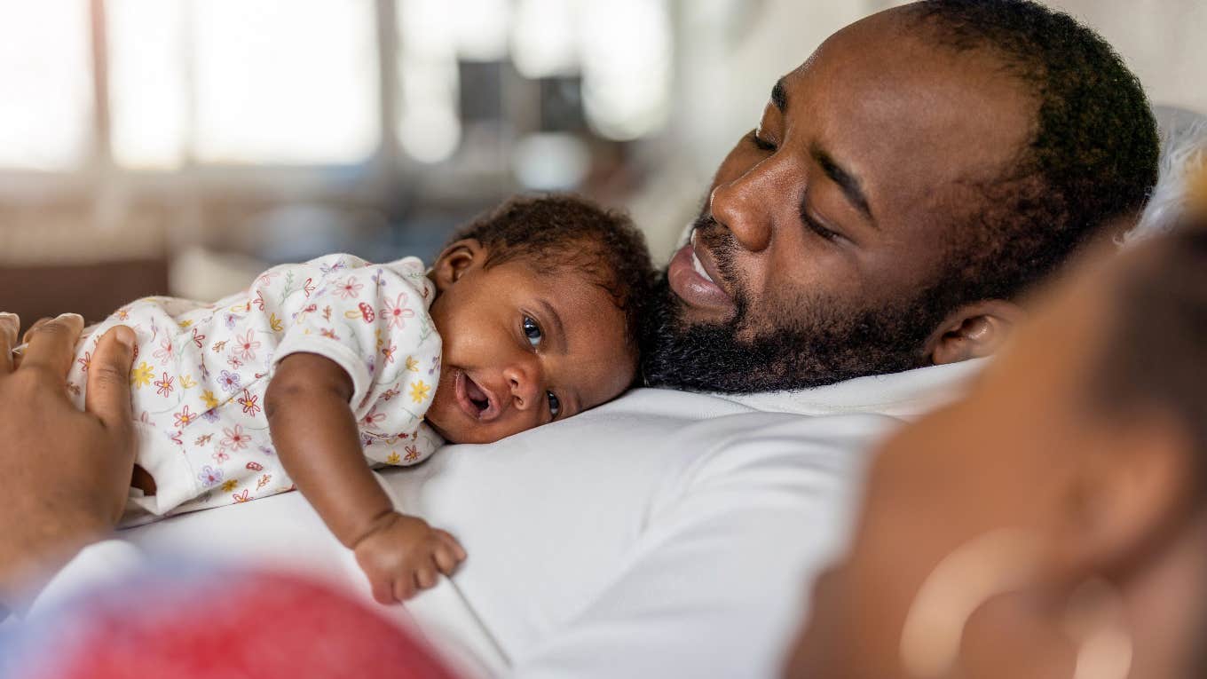 father holding newborn