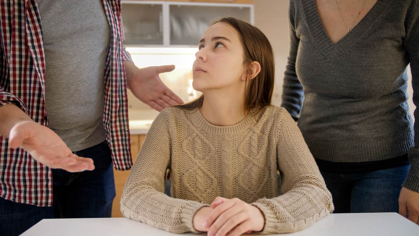 teenage girl looking annoyed at her parents