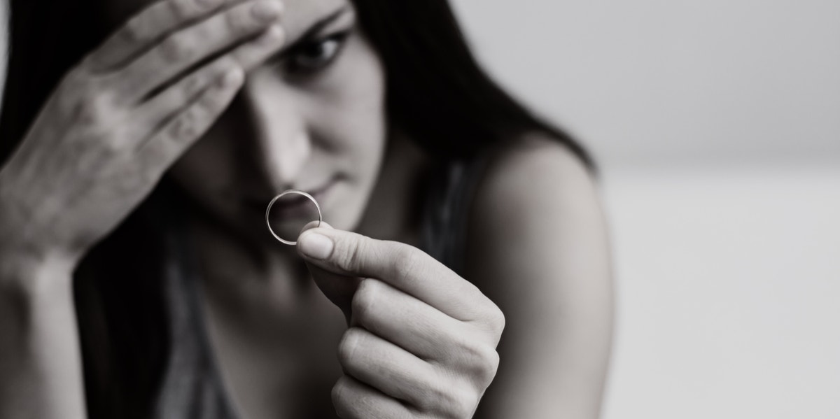 My Parents Forced Me To Stay Married To My Horribly Abusive Husband woman looking at engagement ring in black and white