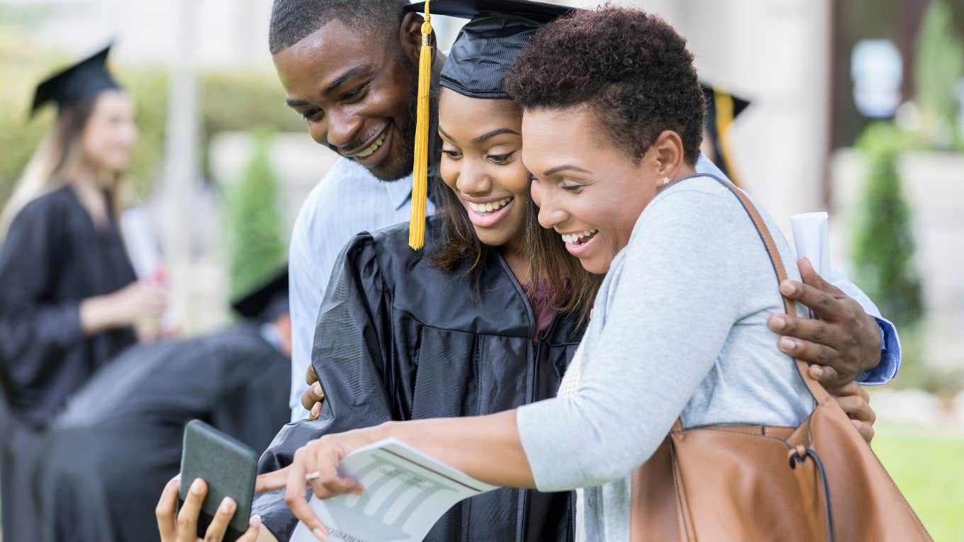 graduating student taking photo with parents