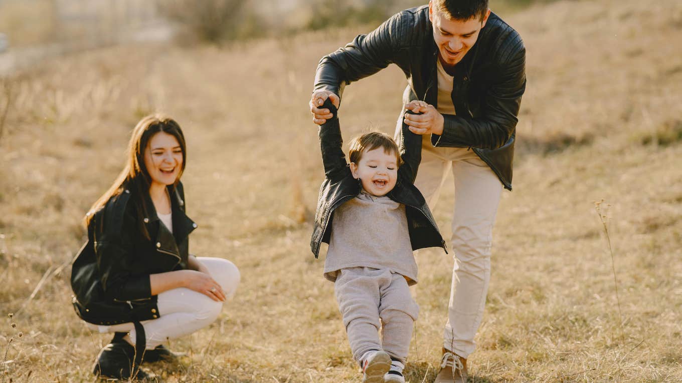 Mother and father playing with their son 