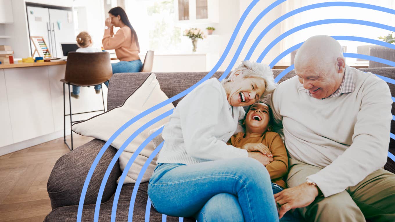 Grandparents playing with their granddaughter while mother focuses