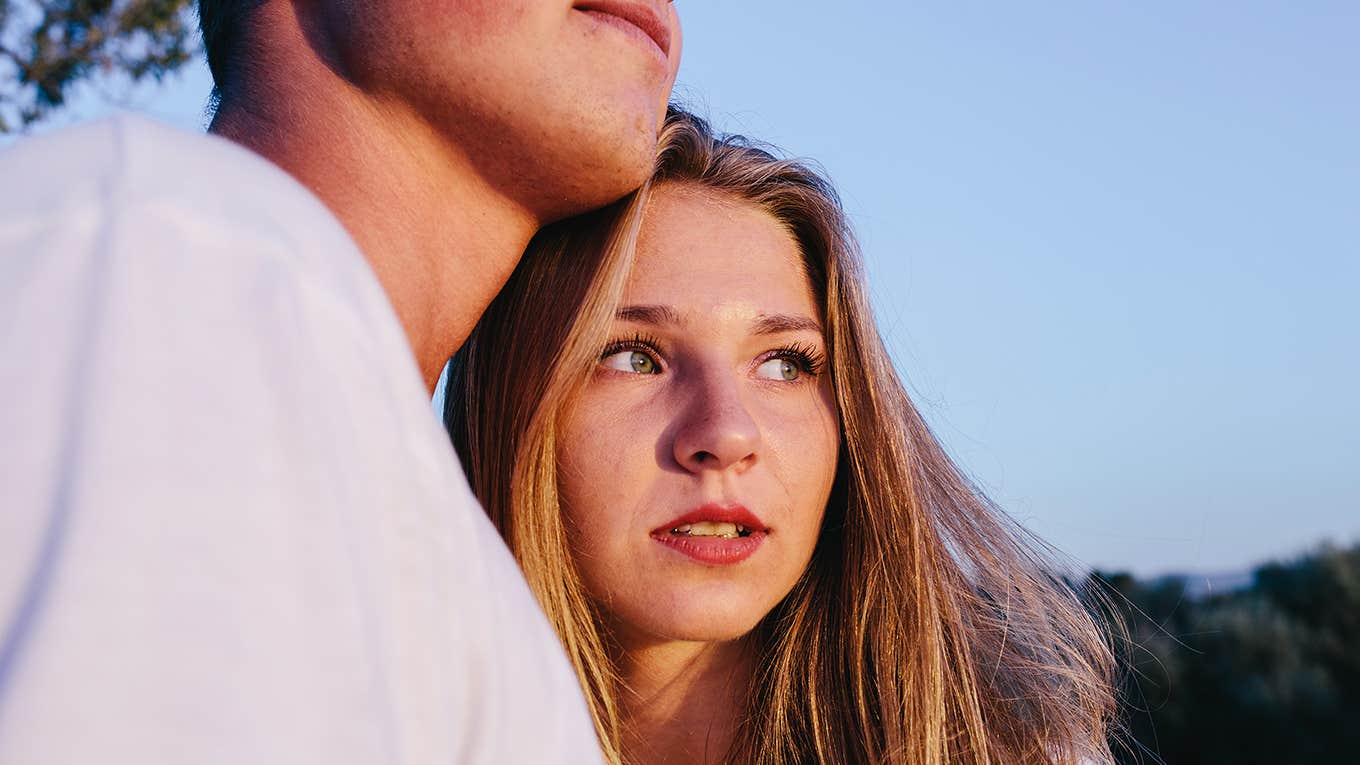 cropped image of a man embracing a young woman