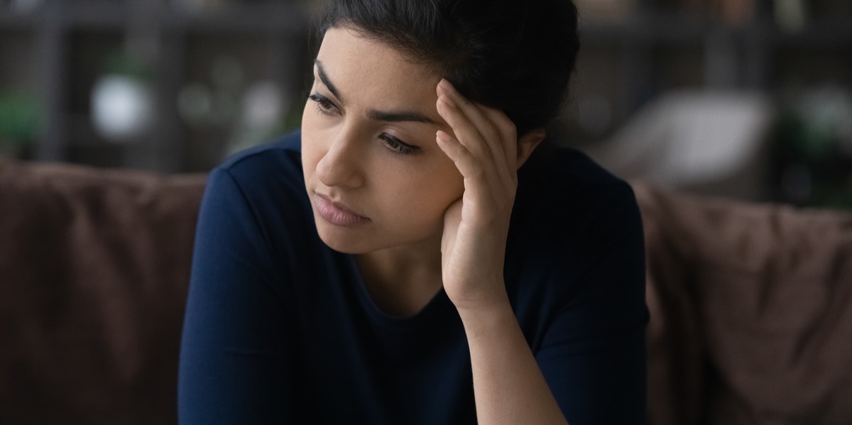 drained woman holding head