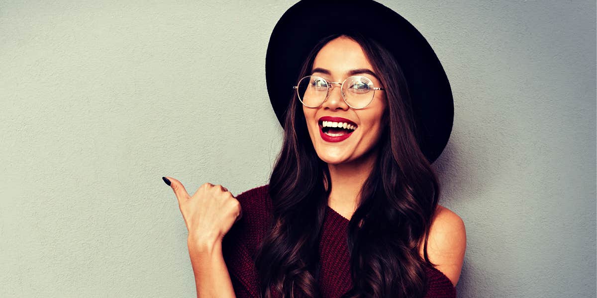 woman in hat smiling 