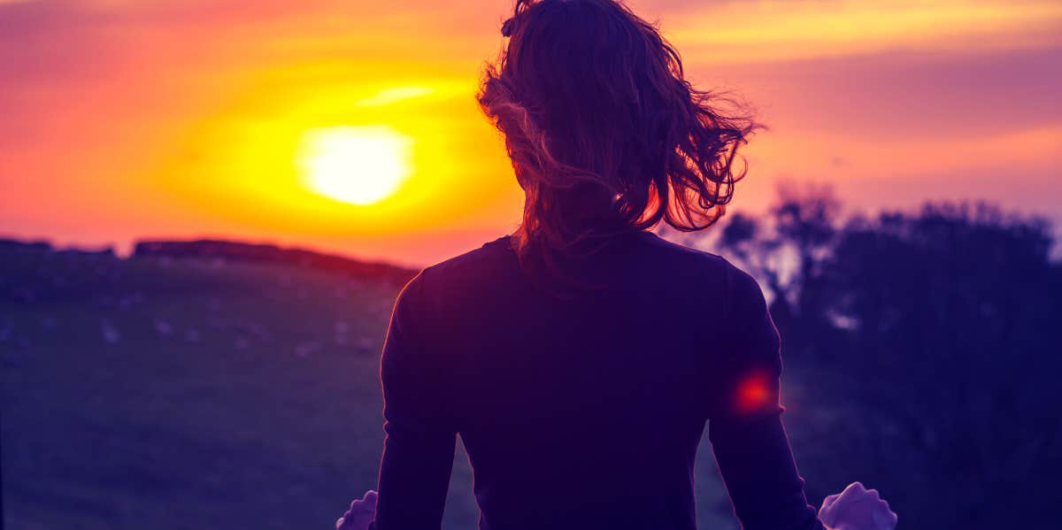 woman looking at sunset