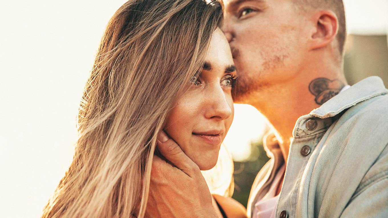 young couple having a tender moment outside