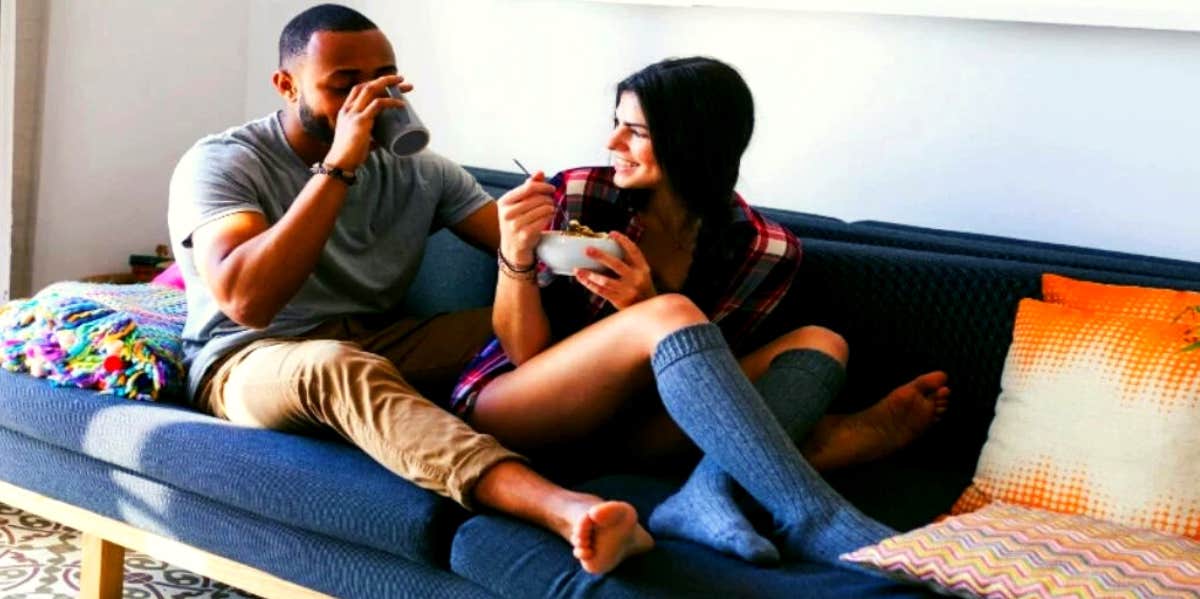 Personal Questions To Ask Someone To Get Them To Open Up happy couple sitting on the couch