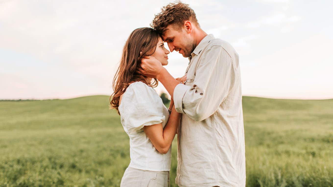 couple kissing in a field