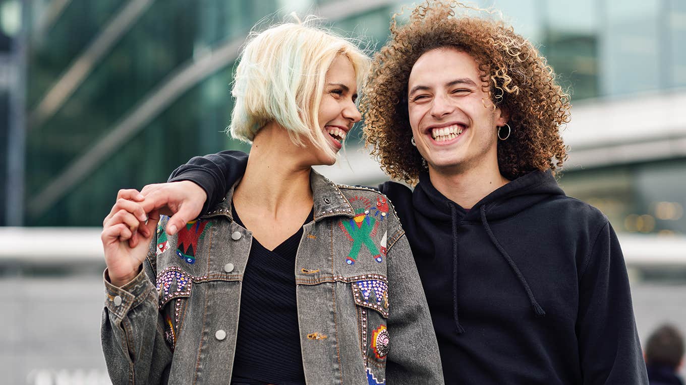 man with arm around girlfriend