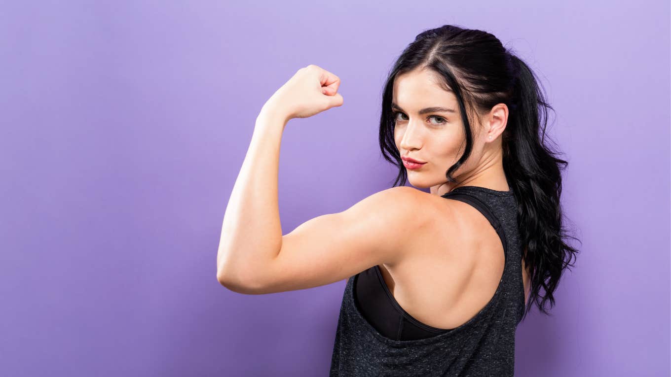strong woman holding up her bicep