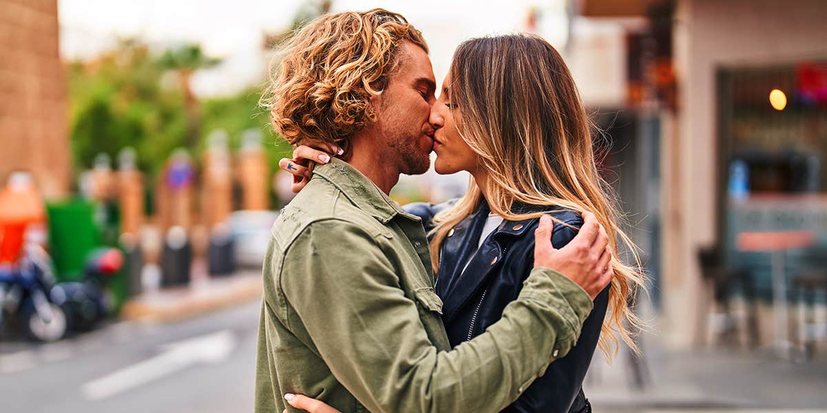 man and woman kissing on street