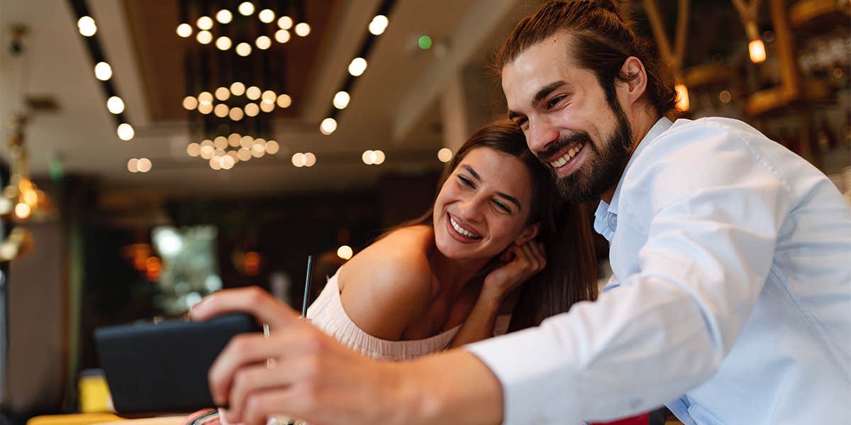 man and woman taking selfie