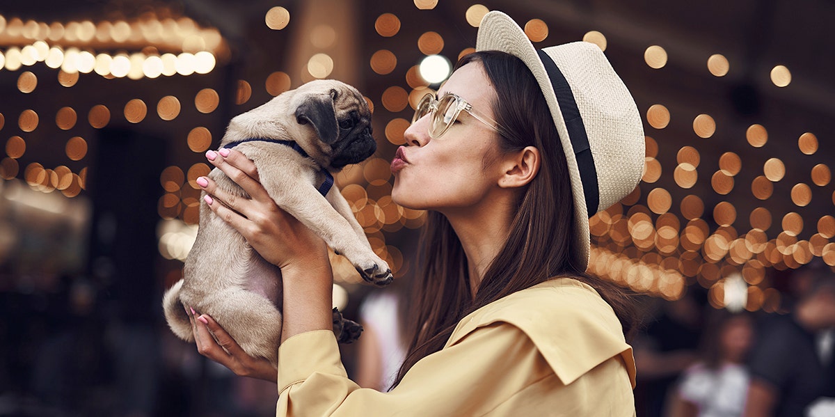 What The Type Of Pet You Choose Says About Your Personality woman kissing puppy