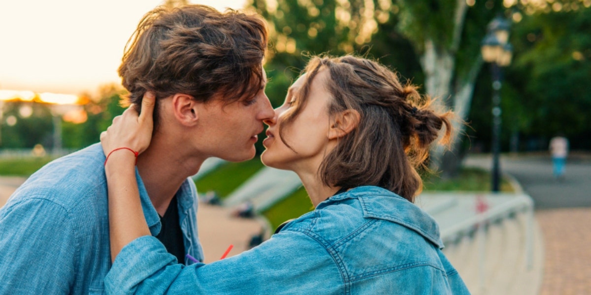 man and woman about to kiss outside