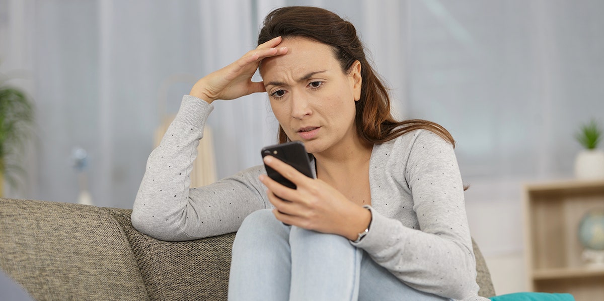 I'm A Married Woman Who Tried Tinder And Whoa, What A Hot Mess woman looking exasperated on phone
