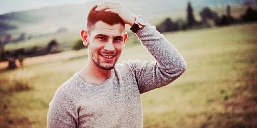 Men With These Personality Traits Are The Least Likely To Break Your Heart man with hand on head standing in field