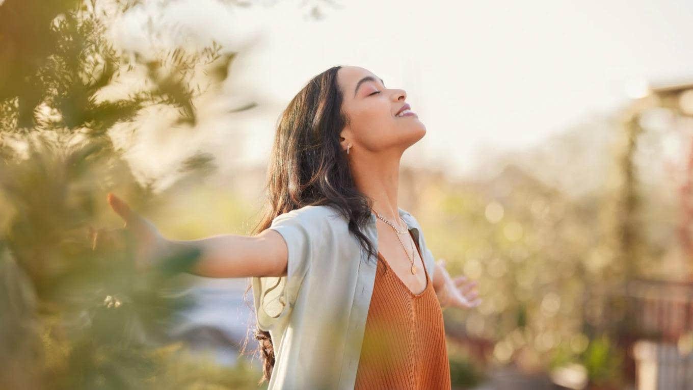 carefree woman with arms open