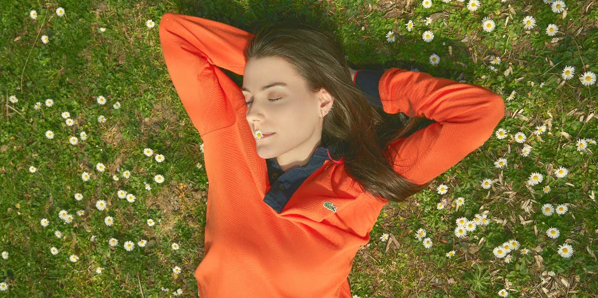 woman laying in a field of flowers