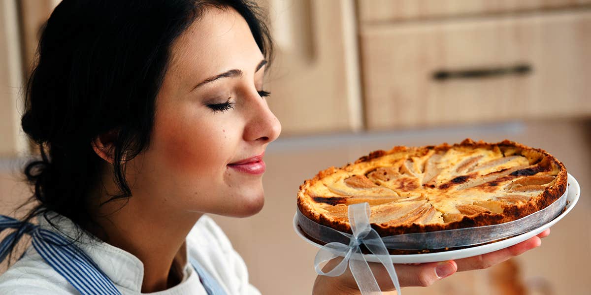 woman smelling fresh apple pie