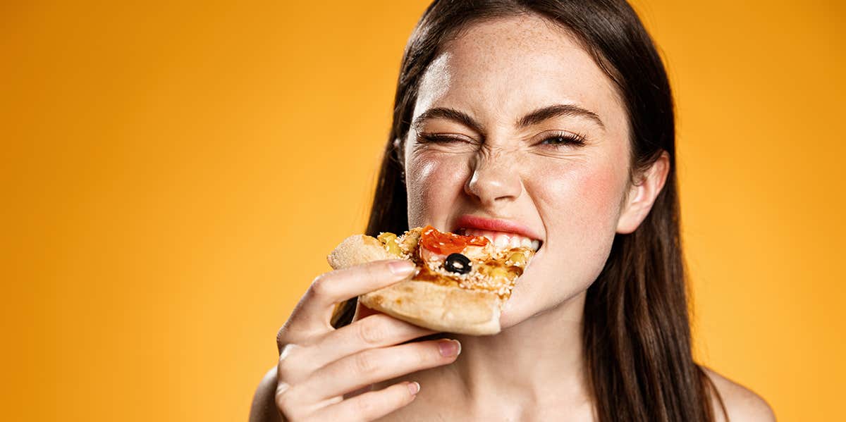 woman eating pizza