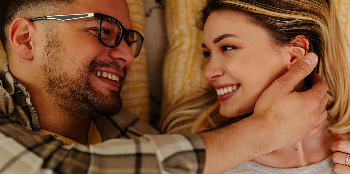 man and woman cuddling smiling at each other