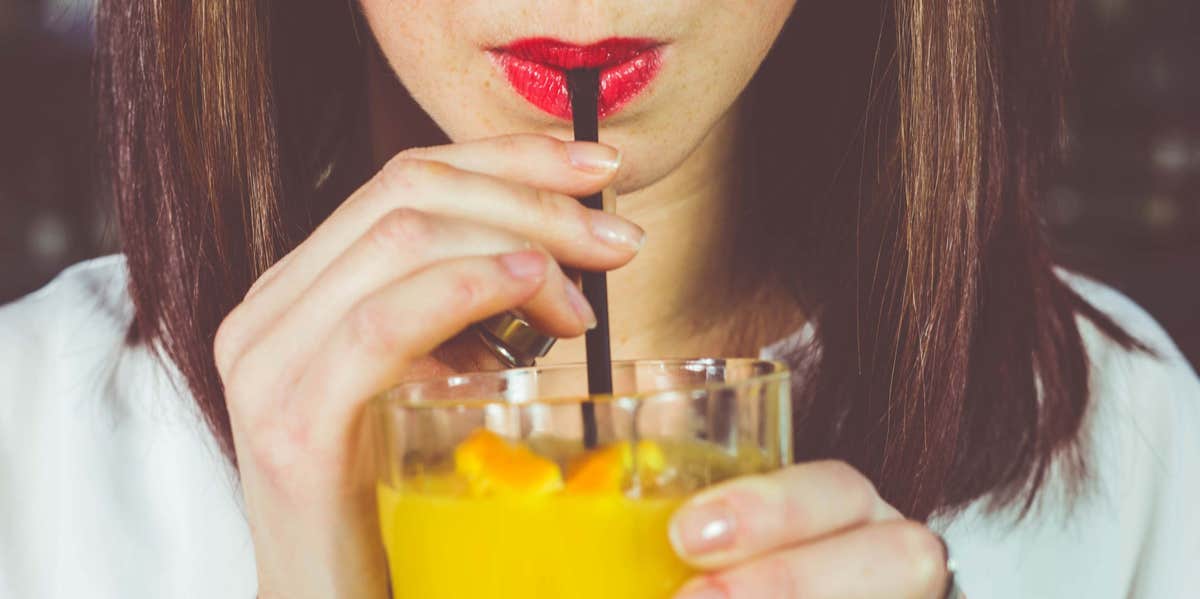 woman drinking cocktail