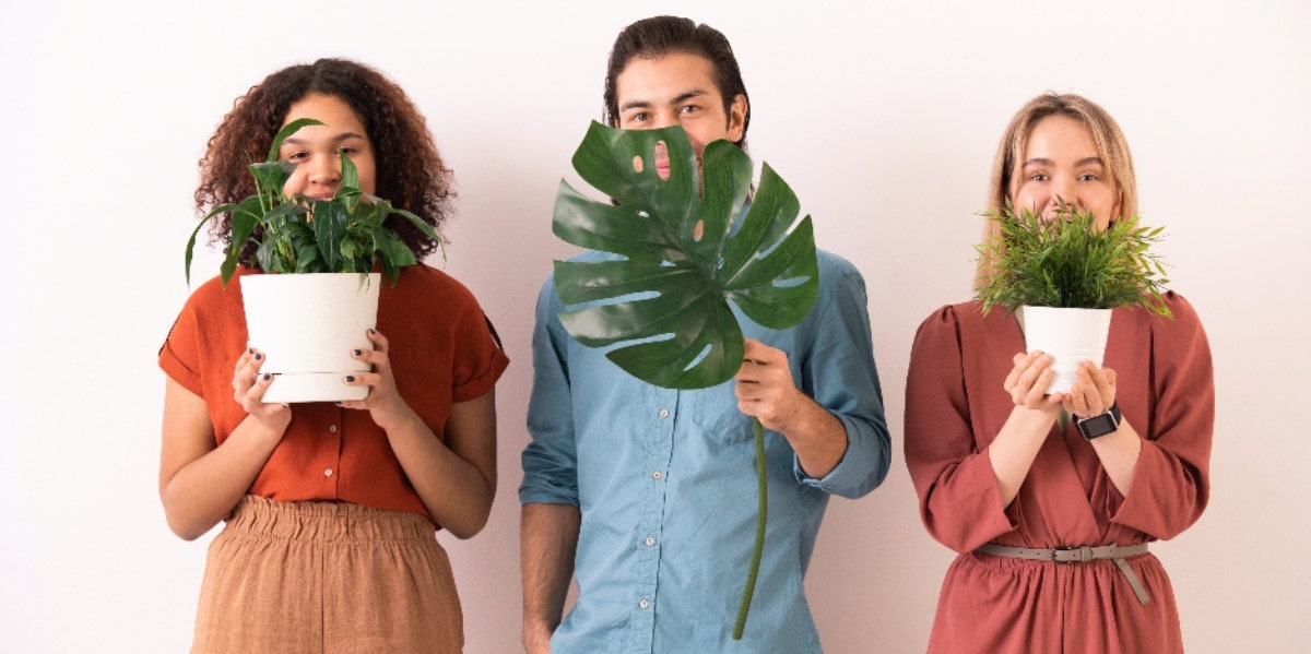 people holding up plants