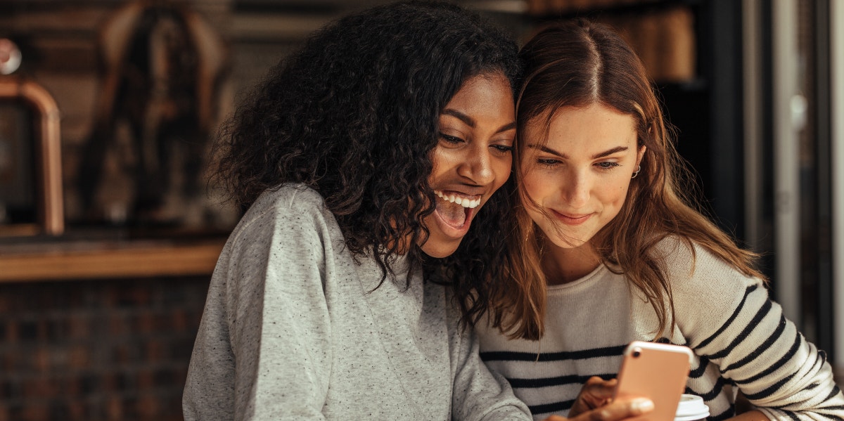 two friends looking at a phone