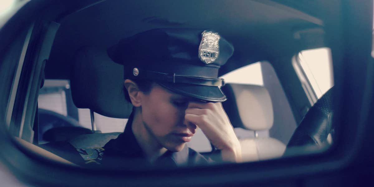 how cops can manage on the job stress cop in the front seat of her car, looking stressed