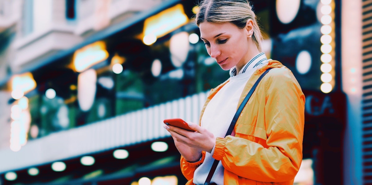 woman in orange texting