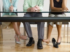 One Man, 4 Wives: Are The Sister Wives Happy? man playing footsie two women polygamy
