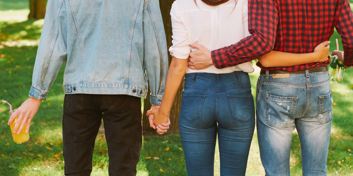 backsides of people linking hands