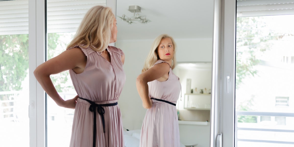 poor body image woman looking in the mirror
