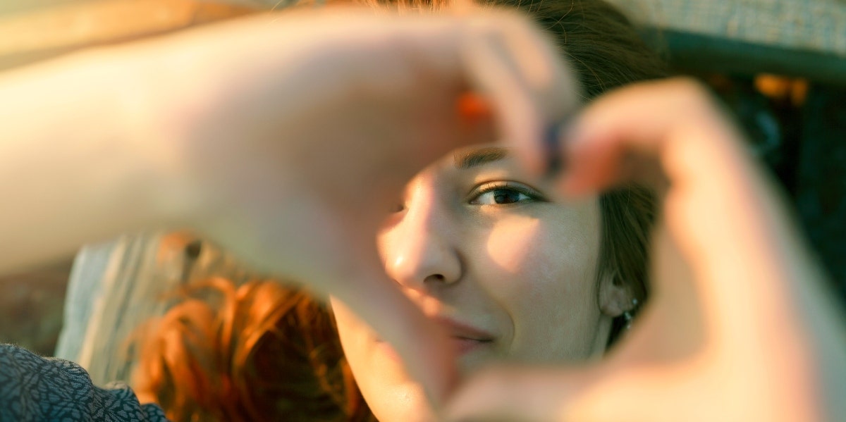 woman forming a heart