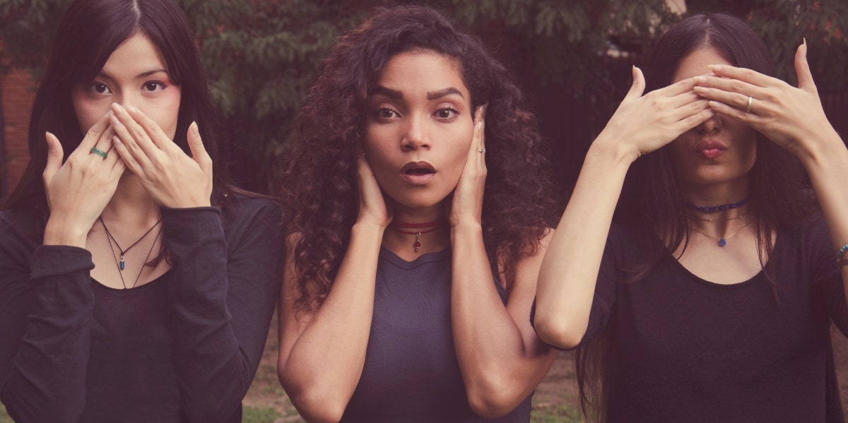 three women covering mouth, ears, and eyes