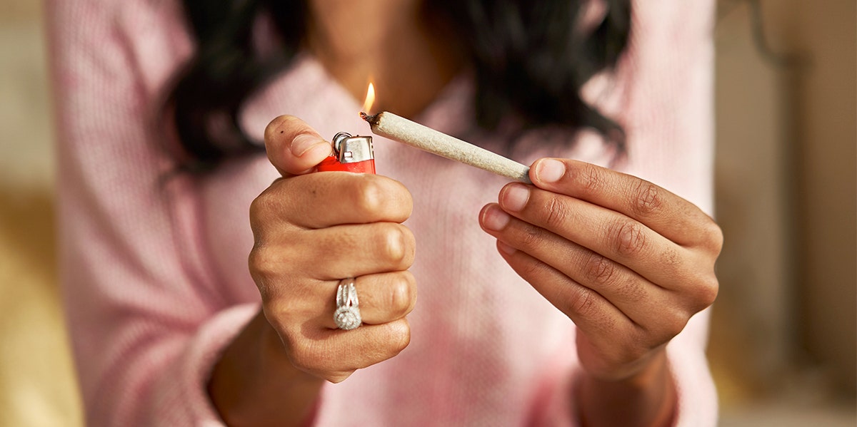 close-up of woman lighting up