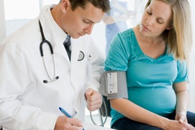 pregnant woman with doctor in clinic