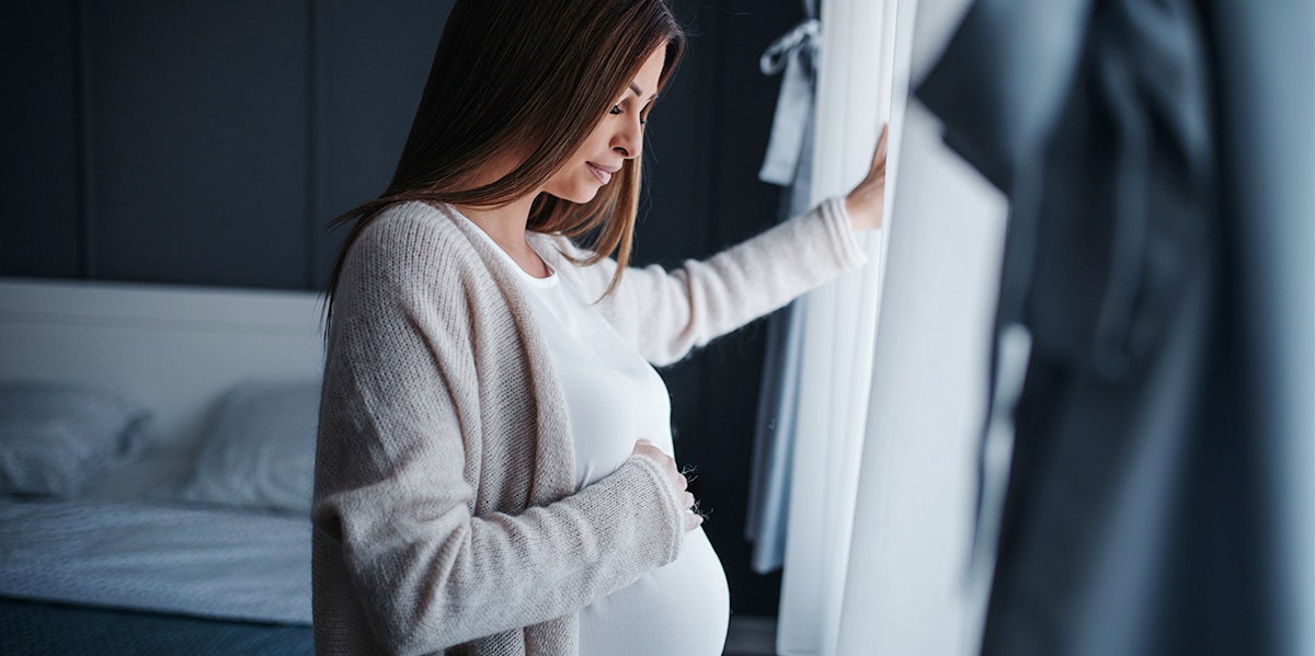 pregnant woman holding belly