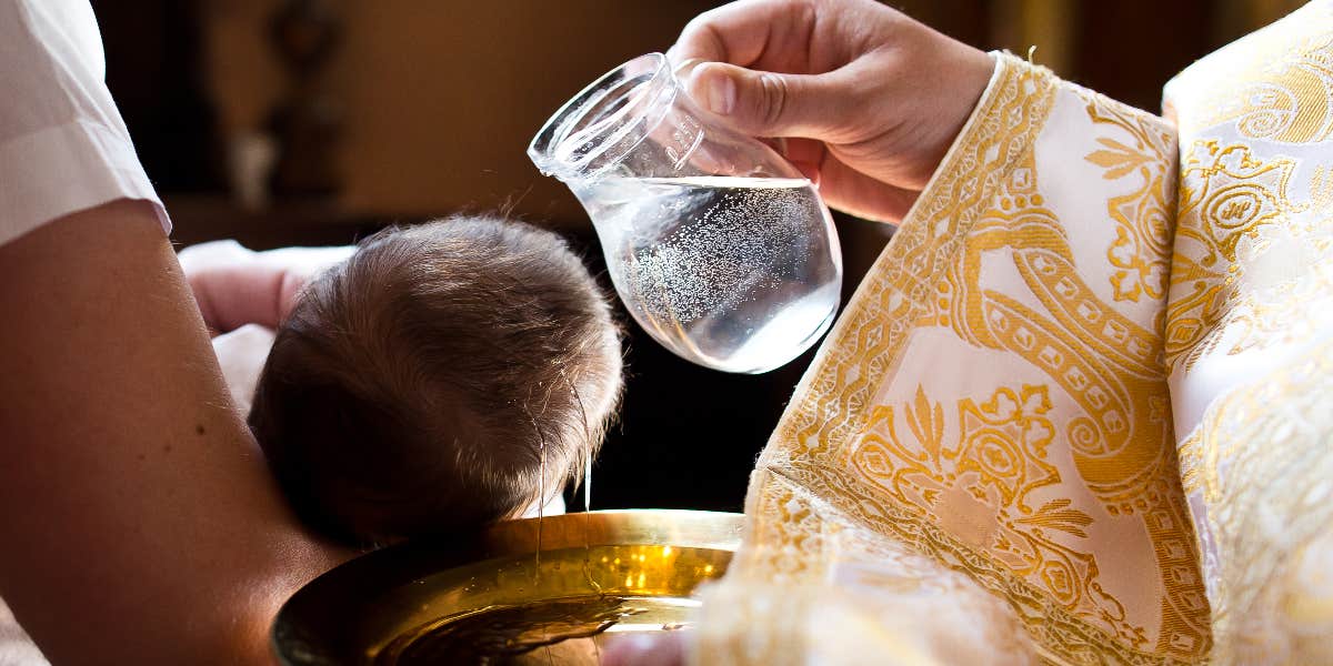 Priest baptizing child