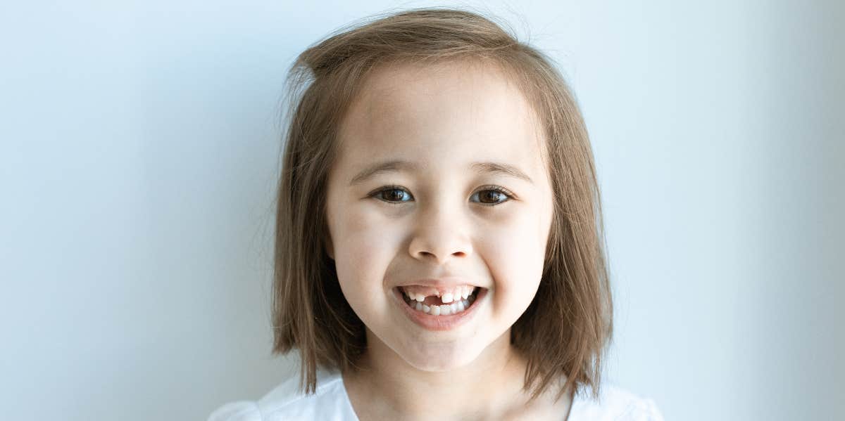 young girl with lost teeth