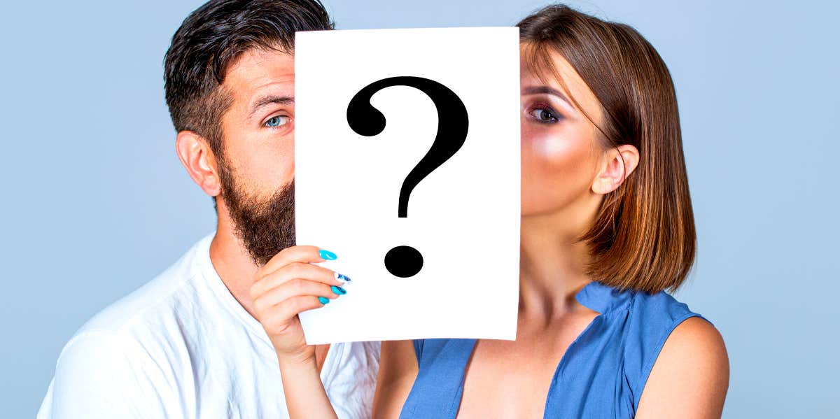 Differences Between A Private Vs Secret Relationship couple hiding their faces behind a paper with a question mark on it