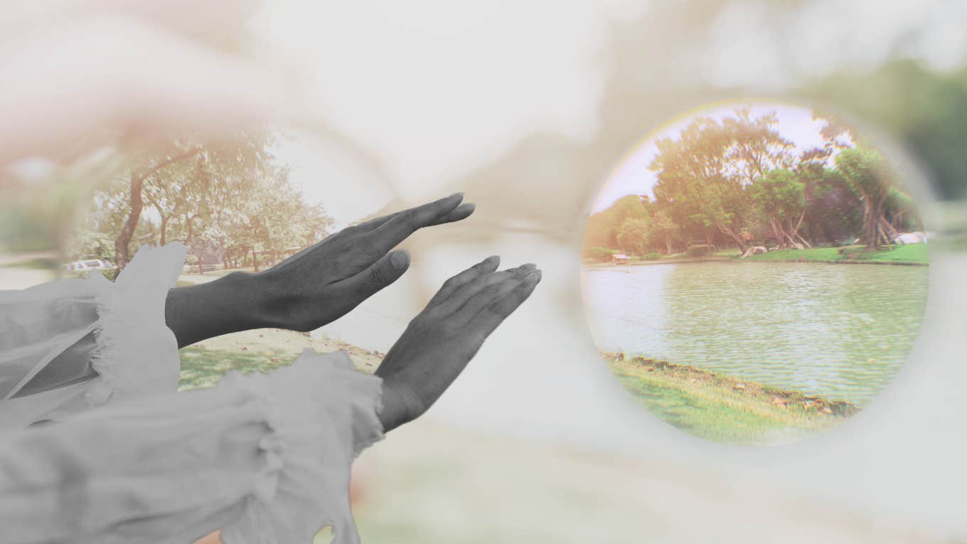 woman feeling around in a blurry world to find her glasses